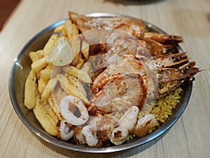 Seafood platter with herb rice and frenchfries