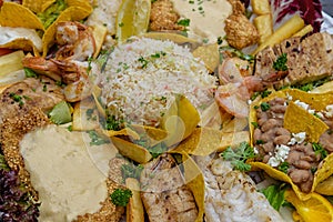 Seafood platter Plato pescado mixto. Different kinds of fish, sauce, beans, rice, lettuce leaves. Top view. Close-up photo