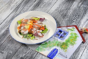 With seafood salad in plate on wooden background