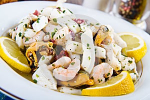 Seafood Salad with prawns, mussels, squids, octopus decorated wi