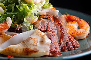 Seafood salad. Shrimps, eel, squids, lettuce. , close-up