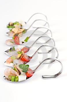 Seafood salad on spoon