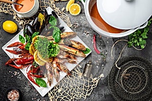 Seafood set. A plate full of cooked shrimp, fish, crayfish, mussels. banner, menu, recipe place for text, top view