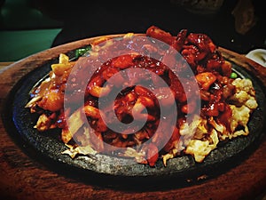Seafood Sizzler with squids basa fish food toping recipes cast iron pan woodbase  yummy taste delicious photo