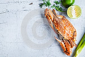 Seafood steamed crab on a white wood background.