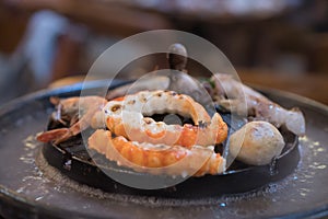 Seafood on steaming and grilling cooker pot