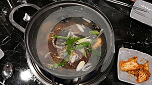 Seafood stew comprising shellfish and prawns in metal pan or pot