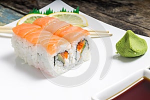 Seafood sushi rolls in plate with chopsticks and japanese spices
