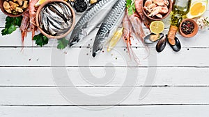Seafood on a white wooden background. Fresh fish, shrimp, oysters and caviar.