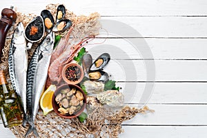 Seafood on a white wooden background. Fresh fish, shrimp, oysters and caviar.
