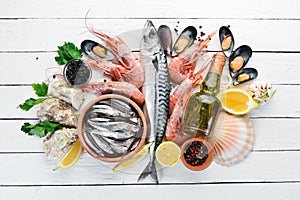 Seafood on a white wooden background. Fresh fish, shrimp, oysters and caviar.