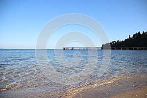 Seafront. Beach And Bay With Long Wooden Bridge