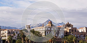 Seafront buildings in Palermo with snowy mountains