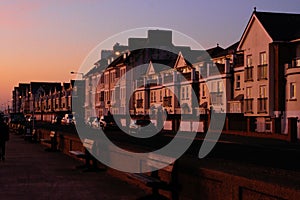 Seafront street with houses at sunset in Seaford, United Kingdom