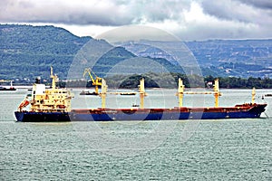 Seagoing vessels, barges, tugboats and small boats at the roadstead of Halong bay under cargo operations and underway. Port of Cam