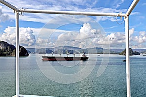 Seagoing vessels, barges, tugboats and small boats at the roadstead of Halong bay under cargo operations and underway. Port of Cam