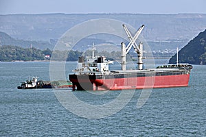 Seagoing vessels, barges, tugboats and small boats at the roadstead of Halong bay under cargo operations and underway. Port of Cam