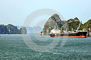 Seagoing vessels, barges, tugboats and small boats at the roadstead of Halong bay under cargo operations and underway. Port of Cam