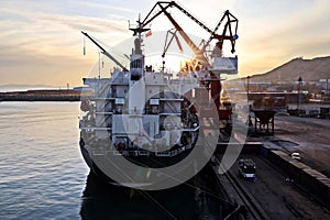 Seagoing vessels, tugboats at the port under cargo operations and underway in the port of Huludao, China, November, 2020.