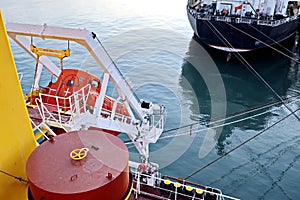 Seagoing vessels, tugboats at the port under cargo operations and underway in the port of Huludao, China, November, 2020.