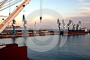 Seagoing vessels, tugboats at the port under cargo operations and underway in the port of Huludao, China, November, 2020.