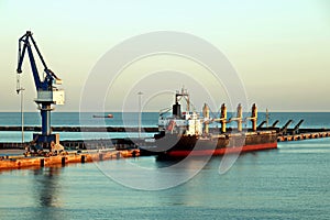 Seagoing vessels, tugboats at the port under cargo operations and underway in the port of Huludao, China, November, 2020.