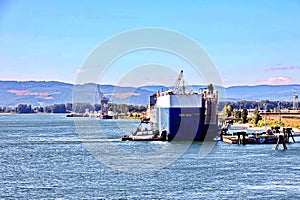 Seagoing vessels and tugboats at the roads and Columbia river of the port of Vancouver, WA, USA. August, 2020.