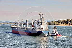 Seagoing vessels and tugboats at the roads and Columbia river of the port of Vancouver, WA, USA. August, 2020.