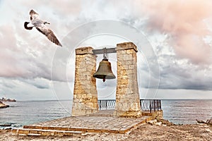 Seagull flies over bell of Chersonesos