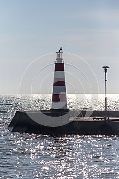 Seagull on the lighthouse, sealine and horizon