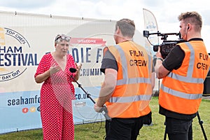 Karen Wright celebrity baker being interviewed by a film crew at Seaham Food Festival