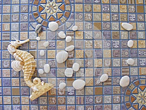 Seahorse and pebbles frame on mosaic background