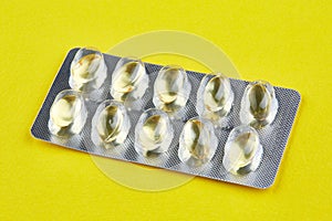 Sealed package with transparent capsules on yellow background