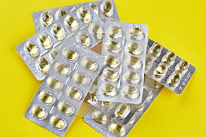 Sealed packages with transparent capsules on yellow background
