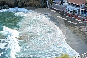 Sealine near the turquoise ocean. Usual beach near the waterline with waves