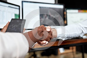 Sealing a deal. Business handshake. Two businessmen, traders reaching an agreement and making a deal. Monitor with