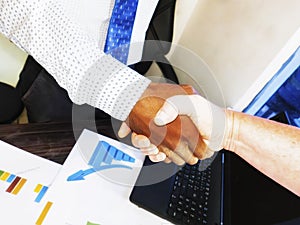 Sealing a deal. Top view of an indian man and caucasian woman shaking hands in office. Multi racial relationship