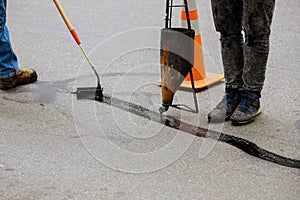 Sealing joint crack in asphalt road surface restoration work