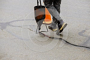 Sealing joint crack in asphalt road surface restoration work