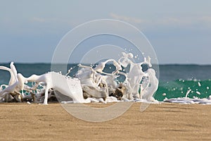 Seam foam created by waves surging on sand and creating amazing texture and patterns.