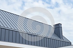 Seam metal roof with hidden eaves gutter