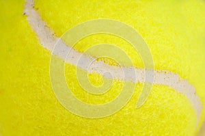 The seam of a yellow tennis ball