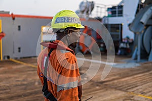Seaman AB or Bosun on deck of offshore vessel or ship , wearing PPE