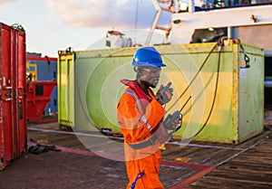 Seaman AB or Bosun on deck of offshore vessel or ship , wearing PPE