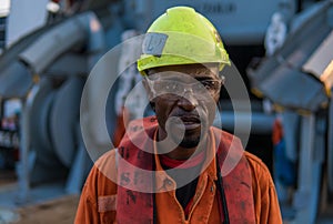 Seaman AB or Bosun on deck of vessel or ship , wearing PPE