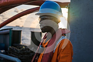 Seaman AB or Bosun on deck of vessel or ship , wearing PPE