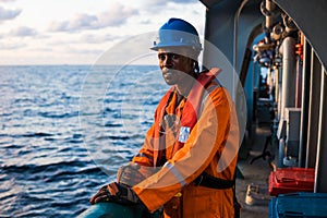 Seaman AB or Bosun on deck of vessel or ship , wearing PPE