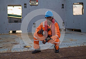 Seaman AB or Bosun on deck of vessel or ship , wearing PPE