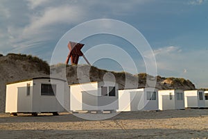 Seamark in sand dunes with beach cabins