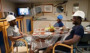 Seamen crew onboard a ship or vessel having fun watching TV photo